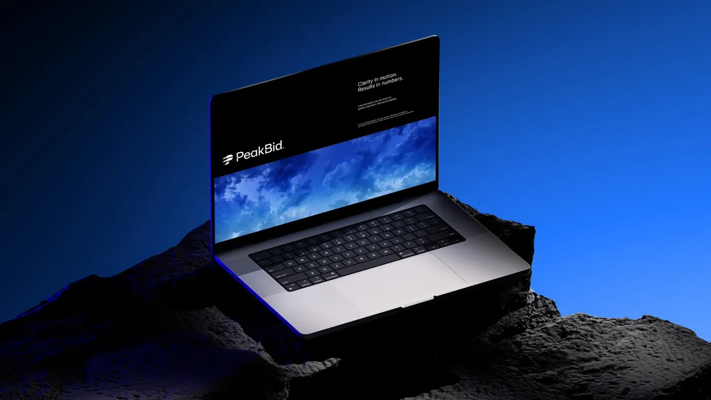PeakBid website on a laptop